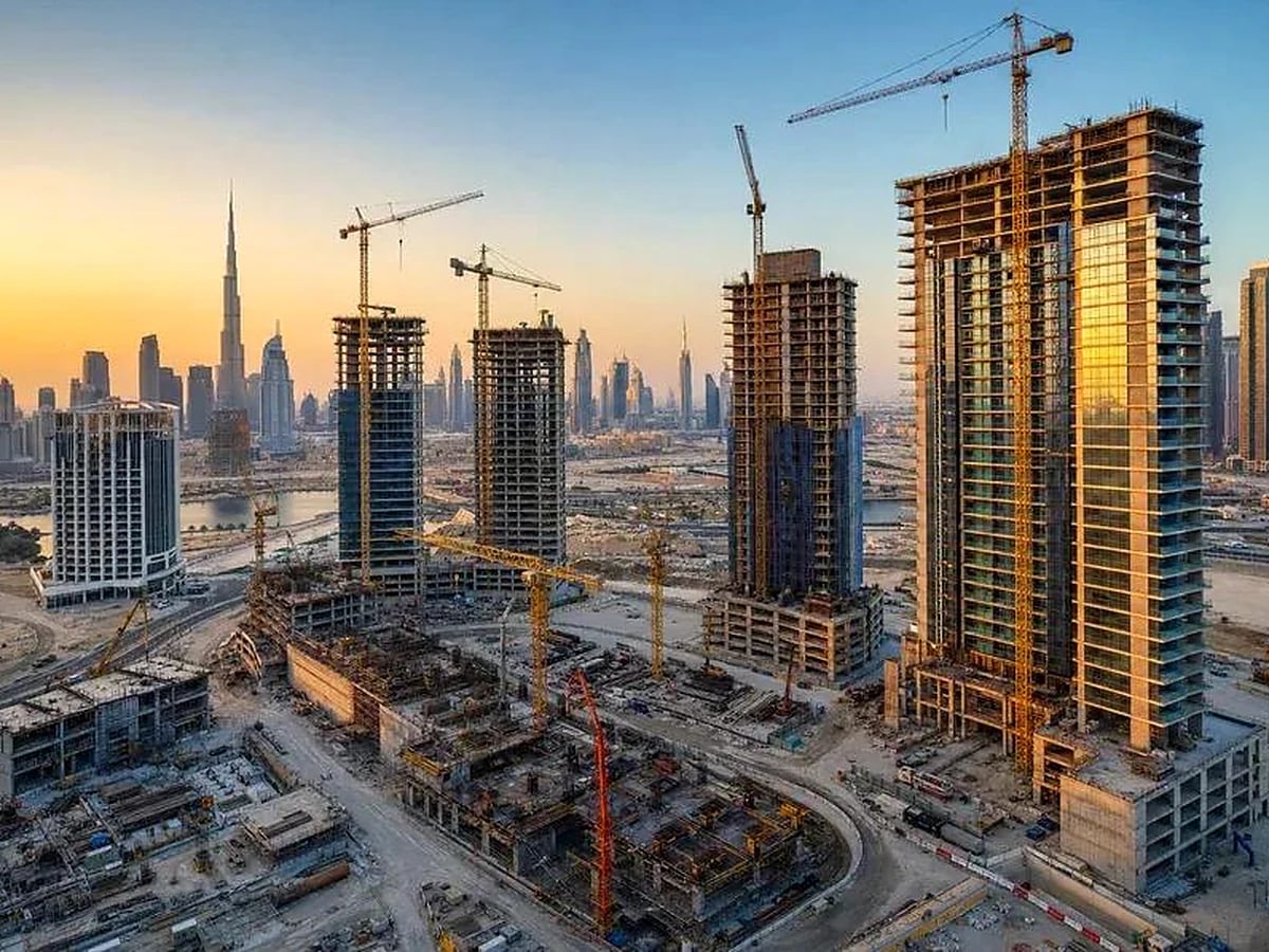 High-rise towers under construction in Dubai at sunset